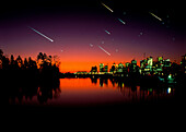 Composite image of meteors over a city at night
