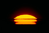 A heavily distorted solar disc at sunset