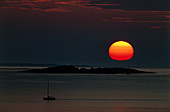 Orange sunset over sea with island