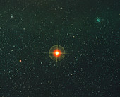 Starfield with the red supergiant Antares