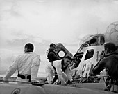Crew of Apollo 13 leaving capsule after splashdown
