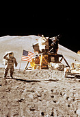 Apollo 15 astronaut Irwin standing next to US flag