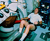 Astronaut using the shuttle's exercise bicycle