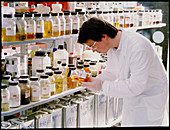 Technician with shelves of oil samples