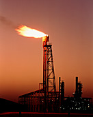 Gas flare in front of an oil refinery