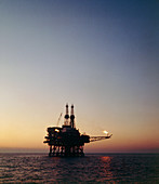 View of an oil rig in the North sea at sunset