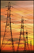 Pylons carrying electricity wires at sunset