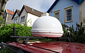 Dome holding satellite dish on radio car
