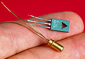 Fingers hold transistors from the 1960s & 1970s