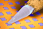 Coloured SEM of micro-accelerometer and pencil tip