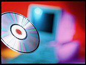 View of CD-ROM disc in front of personal computer