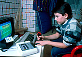 Boy using joystick for personal computer