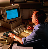 Man reading internet bulletin board on computer