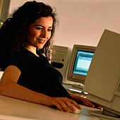 Woman using a personal computer (PC) at home