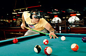 Pool player hitting a shot using virtual goggles