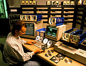 Technician electronically checks compact discs