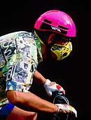 Cyclist wearing anti-smog mask and crash helmet