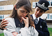 Policewoman comforting woman