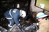 Fire fighters in a burnt house