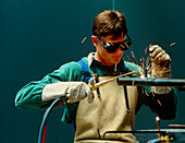 Man welding a pipe using an oxyacetylene torch