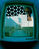 Technician examines model under artificial sky