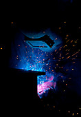 Sparks flying from an argon welder at work