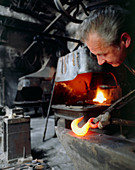 Blacksmith using his anvil
