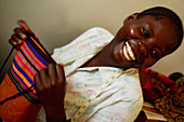 Woman holding a hand sewn bag,Uganda