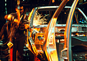 Technician welding in a car body production line
