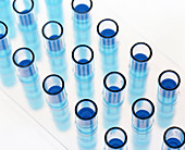 Test tubes containing blue liquid in a rack