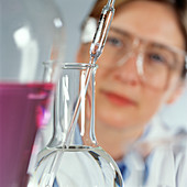 Chemist pipetting liquid