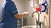 Female nurse washing her hands
