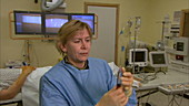 Doctor filling syringe with liquid