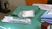 Nurse unwrapping surgical equipment