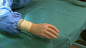 Doctor unfolding hospital sheet