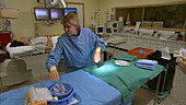 Dr and nurse preparing surgery equipment