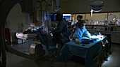 Doctors preparing surgical equipment