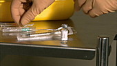 Nurse preparing syringe for injection