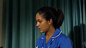 Nurse talking to patient in hospital bed