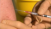 Nurse injecting syringe into man