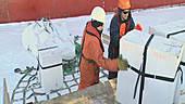 Loading ice core boxes, Antarctica