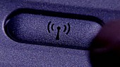 Pressing Bluetooth button close-up