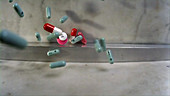 Pills falling onto marble surface