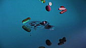 Pills falling into water