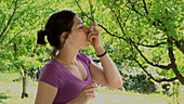 Woman using an asthma inhaler