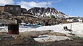 Village and melting snow, Greenland