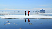 Photographers on an Arctic iceberg