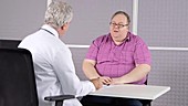 Doctor consulting with obese patient