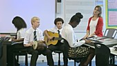 School children learning music