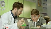 School teacher and schoolboy working in laboratory